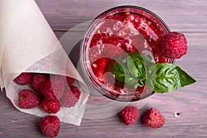 Glass of fresh strawberry smoothie and fresh strawberries on pink wooden background. Healthy food and drink concept