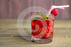 Glass of fresh strawberry smoothie and fresh strawberries on pink wooden background. Healthy food and drink concept