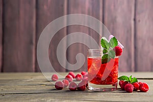 Glass of fresh strawberry smoothie and fresh strawberries on pink wooden background. Healthy food and drink concept