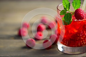 Glass of fresh strawberry smoothie and fresh strawberries on the wooden background. Healthy food and drink concept