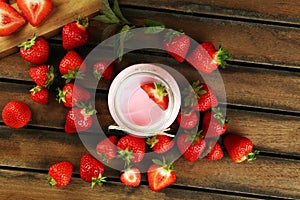 Glass of fresh strawberry yogurt and fresh strawberries on table. Healthy food and drink concept with juicy fresh fruits and dairy