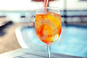 Glass of fresh summer cocktail at poolside outdoors