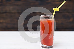 Glass of fresh tomato juice with straw