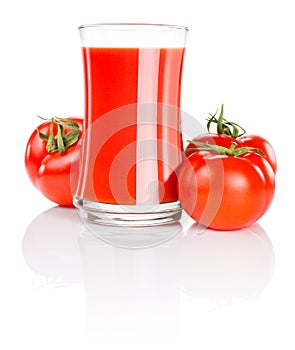 Glass of fresh tomato juice and three tomatoes