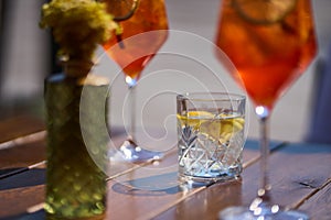 Glass of fresh water with lemon on table