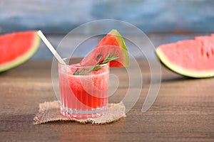 Glass of fresh watermelon juice on wooden table with copy space. Summer drink concept