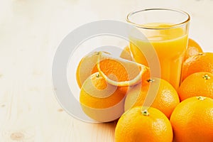 Glass of freshly pressed orange juice with oranges