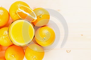 Glass of freshly pressed orange juice with oranges