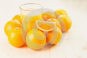 Glass of freshly pressed orange juice with oranges