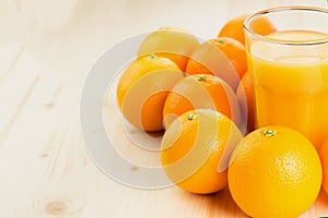 Glass of freshly pressed orange juice with oranges