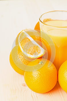 Glass of freshly pressed orange juice with oranges