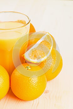 Glass of freshly pressed orange juice with oranges