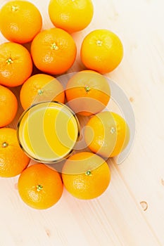 Glass of freshly pressed orange juice with oranges