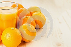 Glass of freshly pressed orange juice with oranges