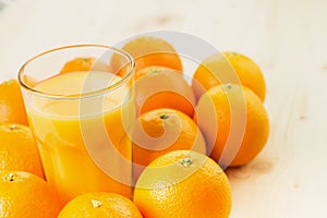 Glass of freshly pressed orange juice with oranges