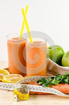 Glass of fruit juice with orange, carrots and ginger photo