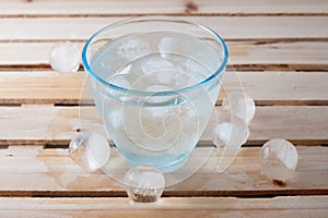 Glass full of pure water with ice balls