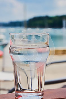 Glass full of water in front of Douarnenez harbor