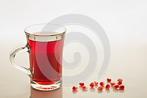 Glass of garnet juice and grain/glass of garnet juice and grain on a white marble. Copy space