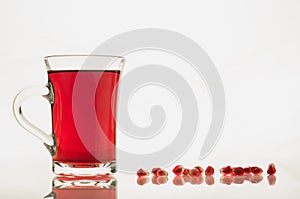 Glass of garnet juice and grain on a white background/glass of g