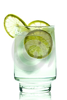 Glass of gin and tonic with ice lime slice