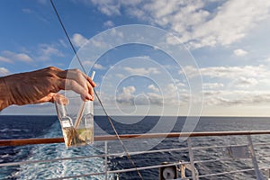 Glass of gin and tonic in a upper deck of cruise ship