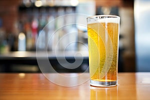 a glass of ginger ale with bubbling carbonation