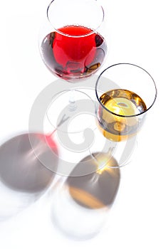 Glass glasses with drinks of different colors on a white background. Top view. The concept of an alcoholic cocktail