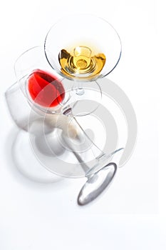 Glass glasses with drinks of different colors on a white background. Top view. The concept of an alcoholic cocktail