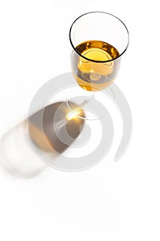 Glass glasses with drinks of different colors on a white background. Top view. The concept of an alcoholic cocktail