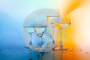 Glass glasses with white wine on a multicolored background