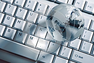 Glass globe on computer keyboard