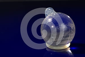 Glass globe with condom