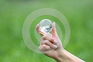 Glass globe in hand