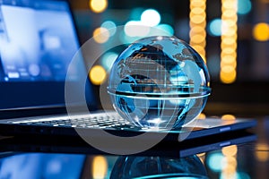 A glass globe on a laptop symbolizes a global business perspective