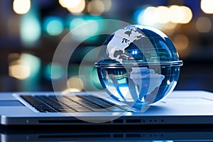 A glass globe on a laptop symbolizes a global business perspective