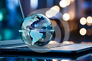 A glass globe on a laptop symbolizes a global business perspective