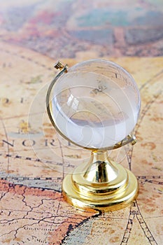 Glass globe and old map