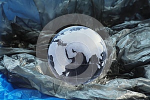 Glass globe with pictured continents Eurasia and Africa with gray and blue package.