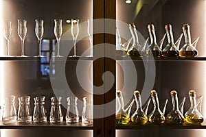 Glass goblets and bottles in a wooden cabinet