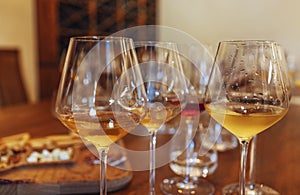 Glass goblets placed in rows on table during wine tasting procedure in restaurant