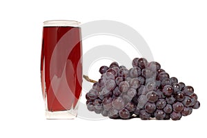 A glass of grape juice with a cluster of grapes