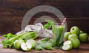 Glass of green juice smoothie with spinach, apple and celery