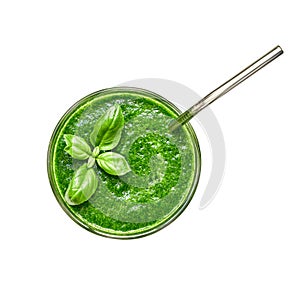 Glass of green smoothie with stainless steel drinking straw and basil leaves, isolated over white wih clipping path. Top view