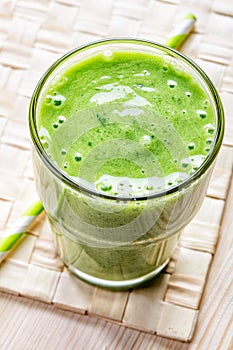 Glass of green smoothie, top view