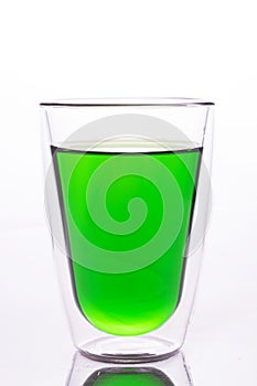 Glass of green water made by food color