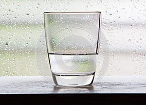 Glass with half a glass of water scenes with condensation glass.