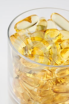 Glass of health with fish oil capsules