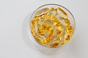 Glass of health with fish oil capsules