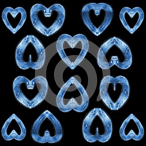 Glass hearts in water drops on a black square background
